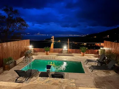 a swimming pool in a yard at night at Taş Devri Konaklama in İznik