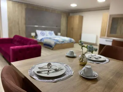a dining room table with plates and utensils on it at Luxury Suit
