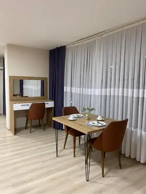 a dining room with a table and chairs in a room at Luxury Suit