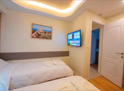 a bedroom with a bed and a flat screen tv at Mar Boutique Hotel in Istanbul