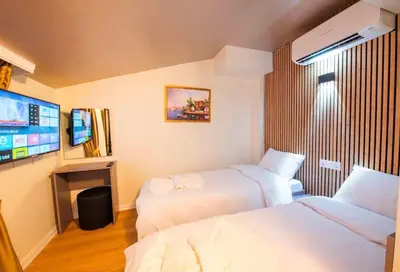 a hotel room with two beds and a flat screen tv at Mar Boutique Hotel in Istanbul