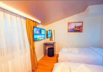 a hotel room with two beds and a television at Mar Boutique Hotel in Istanbul