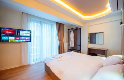 a hotel room with a large bed and a flat screen tv at Mar Boutique Hotel in Istanbul