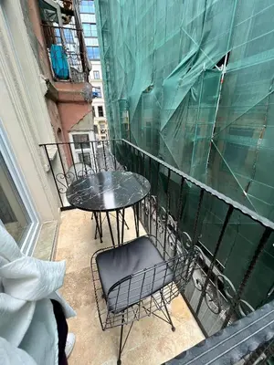 a balcony with a table and chairs on a building at 360 NACRE taksim in Istanbul