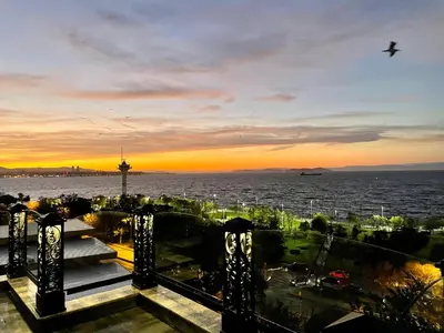a view of a sunset from the balcony of a building at Marmara Konak Old City in Istanbul