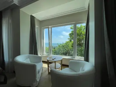 a living room with two chairs and a large window at Marmara Konak Old City in Istanbul