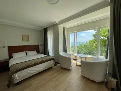 a bedroom with a bed and a large window at Marmara Konak Old City in Istanbul