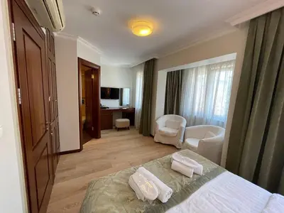a hotel room with a bed and a living room at Marmara Konak Old City in Istanbul