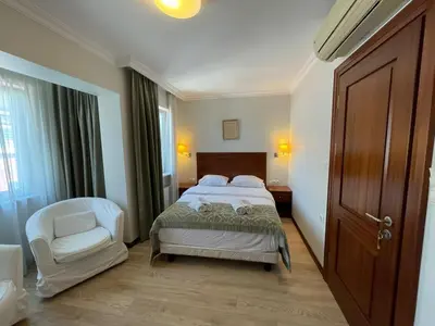 a bedroom with a bed and a chair in it at Marmara Konak Old City in Istanbul