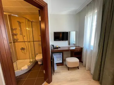 a bathroom with a shower and a sink and a toilet at Marmara Konak Old City in Istanbul