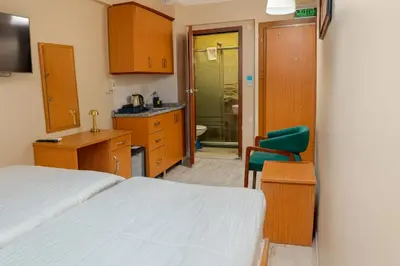 a bedroom with a bed and a bathroom with a sink at Lion Stone Hotel in Istanbul