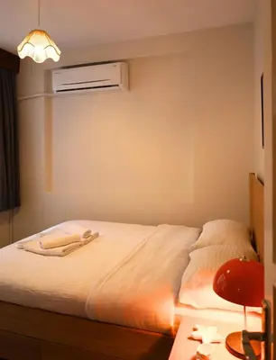 a bedroom with a bed with a white sheets at Modern Apartment in the Heart of Kadıköy in Istanbul