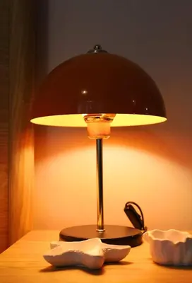 a lamp sitting on top of a wooden table at Modern Apartment in the Heart of Kadıköy in Istanbul