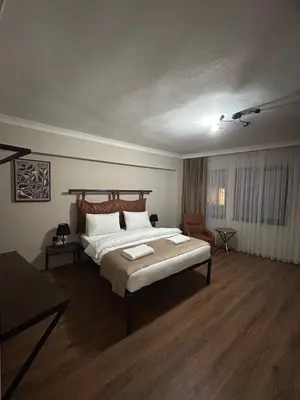 a bedroom with a large bed and a chair at Pera Line Yalova in Yalova