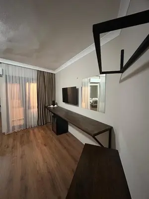 a living room with a table and a mirror at Pera Line Yalova in Yalova