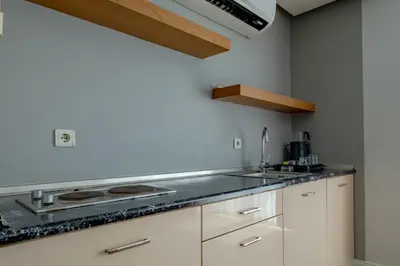 a kitchen with white cabinets and a stove top oven at My SUİTES in Istanbul