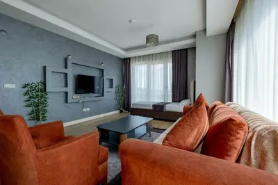 a living room with a couch and chairs and a tv at My SUİTES in Istanbul