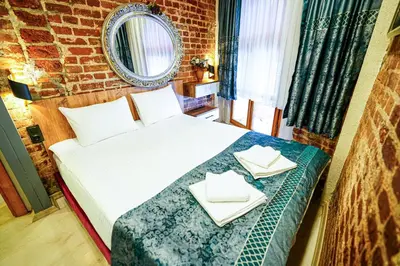 a bedroom with a bed with two white towels on it at İstanbul Galata Squit Apartments in Istanbul
