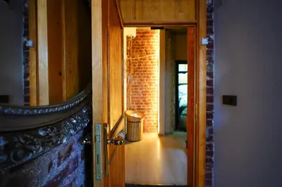 an open door to a hallway with a brick wall at İstanbul Galata Squit Apartments in Istanbul