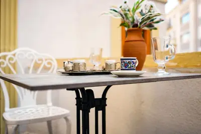 a table with a plate of food and a glass at İstanbul Galata Squit Apartments in Istanbul