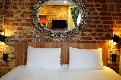 a bedroom with a bed with a mirror above it at İstanbul Galata Squit Apartments in Istanbul