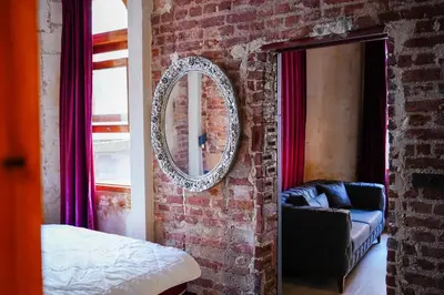 a room with a mirror on a brick wall at İstanbul Galata Squit Apartments in Istanbul