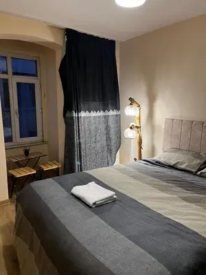 a bedroom with a large bed and a window at Do Not Disturb Suites in Istanbul