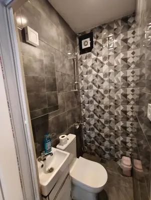a small bathroom with a toilet and a sink at Do Not Disturb Suites in Istanbul