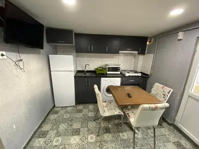 a small kitchen with a table and a refrigerator at Orange Airport Hotel in Istanbul