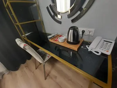 a glass table with a coffee maker on top of it at Orange Airport Hotel in Istanbul