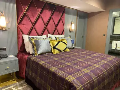 a bedroom with a large bed with a purple headboard at Bof Hotels Uludağ Ski&Luxury Resort All Inclusive in Uludag