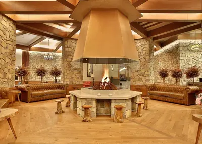 a large living room with a fireplace in the middle at Bof Hotels Uludağ Ski&Luxury Resort All Inclusive in Uludag