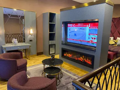 a living room with a fireplace and a tv at Bof Hotels Uludağ Ski&Luxury Resort All Inclusive in Uludag