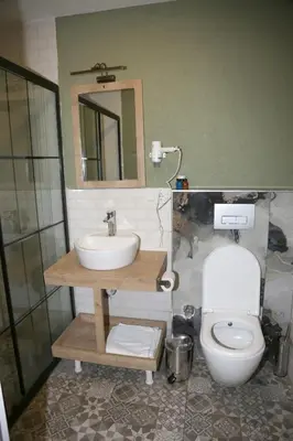 a bathroom with a sink and a toilet and a mirror at Zoom Airport Hotels in Istanbul