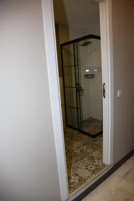 a bathroom with a mirror and a walk in shower at Zoom Airport Hotels in Istanbul