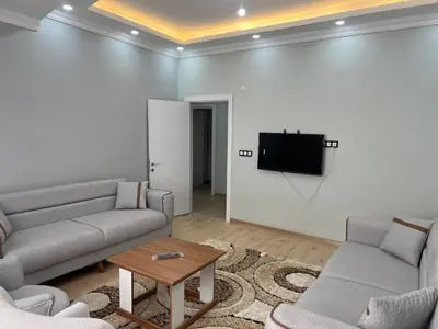 a living room with two couches and a flat screen tv at Bediroğlu Airport Apart in Arnavutköy
