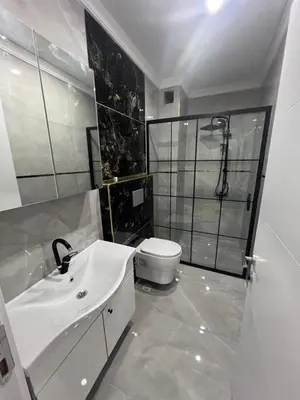 a bathroom with a sink and a shower and a toilet at Bediroğlu Airport Apart in Arnavutköy