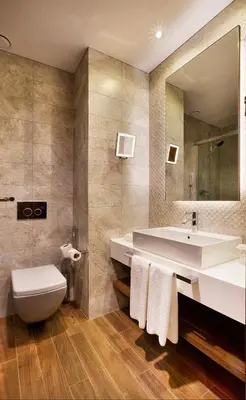 a bathroom with a sink and a toilet and a mirror at Holiday Inn Istanbul - Kadikoy by IHG in Istanbul