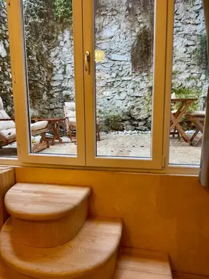 a bench in a room with two windows at Historic Design 3-Storey Arnavutköy Home with Patio in Istanbul