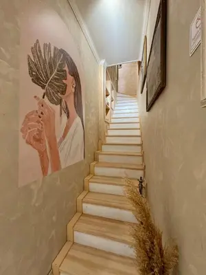 a stairway with a painting of a woman on the wall at Historic Design 3-Storey Arnavutköy Home with Patio in Istanbul
