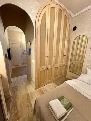 a bedroom with a bed and a room with a hallway at Historic Design 3-Storey Arnavutköy Home with Patio in Istanbul