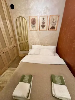 a small bedroom with a bed with towels on it at Historic Design 3-Storey Arnavutköy Home with Patio in Istanbul