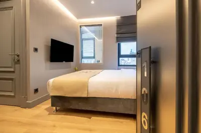a bedroom with a bed and a flat screen tv at İstanbul Platine Apartment in Taksim