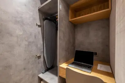 a laptop computer sitting on a desk in a bathroom at İstanbul Platine Apartment in Taksim