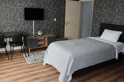 a bedroom with a bed and a desk with a television at DT Suites in Istanbul