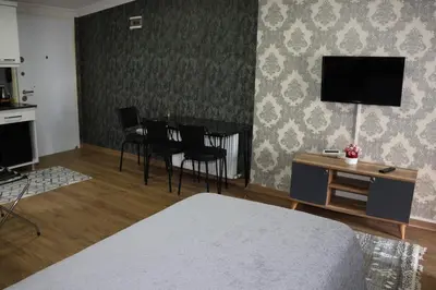 a bedroom with a bed and a table and chairs at DT Suites in Istanbul