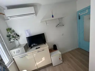 a small room with a tv and a refrigerator at The Rodin Taksim in Istanbul