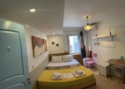 a small bedroom with a bed and a table at The Rodin Taksim in Istanbul