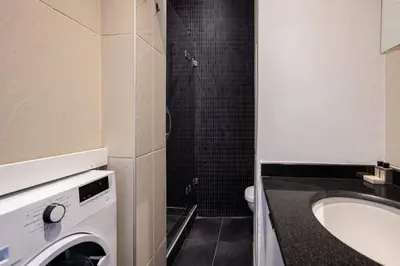a bathroom with a washing machine and a sink at Charming 2BD2Bath Galata Tower Unique Home! #409 in Istanbul