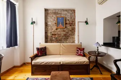 a living room with a couch and a brick wall at Charming 2BD2Bath Galata Tower Unique Home! #409 in Istanbul